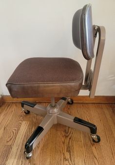 an office chair sitting on top of a wooden floor