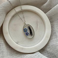 This handmade necklace is a unique piece that holds a special connection to a loved one. The resin not only preserves the hair, but also adds a beautiful and glossy finish to the necklace. This necklace serves as a beautiful reminder of the bond shared with a loved one, allowing the wearer to keep them close at all times. Perfect for Grief Gift, Loss Gift, Loss of mom gift, Loss of grandma gift, Hair keepsake jewelry, Lock of hair keepsake, Hair memorial jewelry, Lock of hair jewelry, Hair keeps Delicate Handmade Oval Pendant Necklace, Handmade Memorial Necklace With Oval Pendant, Hair Memorial Jewelry, Lock Of Hair Keepsake, Hair Keepsake, Lock Of Hair, Hair Necklace, Hair Locks, Keepsake Jewelry