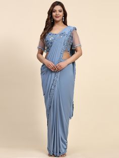 Stitched Saree with blouse in Powder blue colour 102073A A full-stitch drape saree is a contemporary take on the traditional Indian saree, combining the elegance of the drape with the convenience of a pre-stitched garment. This innovative design features a pre-pleated pallu and a stitched skirt, offering ease of wear without compromising on style. Ideal for modern women who appreciate the grace of a saree but seek practicality in their attire, the full-stitch drape saree allows for effortless dr Festive Blue Pre-draped Saree For Evening, Eid Special Zari Work Pre-draped Saree, Festive Draped Saree With Resham Embroidery, Semi-stitched Draped Saree For Reception, Blue Draped Lehenga For Reception, Blue Georgette Pre-draped Saree With Self Design, Blue Draped Lehenga With Unstitched Blouse, Bollywood Style Saree With Unstitched Blouse, Fitted Blue Pre-draped Saree For Festive Occasions