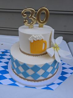 a birthday cake with a beer mug and number 30 on top