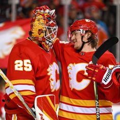 two hockey players standing next to each other