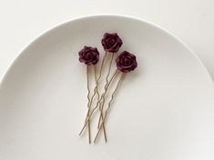 Enhance your bridal hairstyle with this set of three wedding hair pins, each featuring a beautifully crafted burgundy polymer rose. The rich, deep color of the roses adds a touch of romance and sophistication to your look, making these pins perfect for brides seeking a unique and elegant accessory. Style: Kasey W: 0.75" (2 cm) H: 3.5" (9 cm)  Due to the handcrafted nature, slight variations may be present between pieces, adding to their charm and individuality. These small differences make each Flower Hair Piece, Flower Hair Pieces, Gold Hair Pin, Wedding Hair Pins, Rose Hair, Bridal Headpiece, Gold Hair, Elegant Accessories, Flower Hair