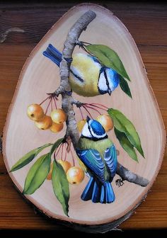 a painting of two birds perched on a tree branch with fruit hanging from it's branches