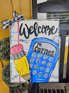 a welcome sign with a drawing of a calculator and a pencil on it