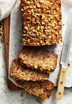 sliced loaf of banana nut bread sitting on top of a cutting board