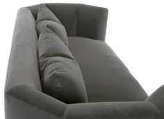 the back end of a gray couch on a white background