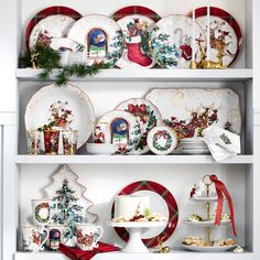 christmas plates and dishes are on display in a china cabinet