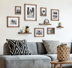 a living room filled with furniture and framed pictures on the wall above it's couch