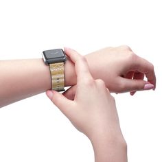 two hands holding onto an apple watch with wood bands on each wrist and the other hand