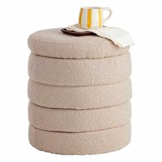 a stack of pillows with a coffee cup on top