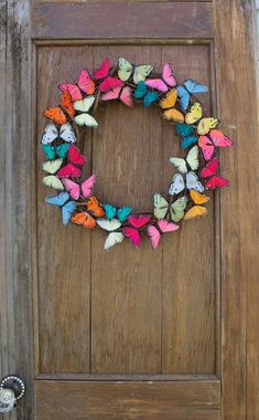 a wooden door with a wreath made out of paper butterflies