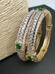 Traditional Bangles comes in set of 2Color : GoldenSize : Size : 2.4Stones : AD Green Stone Green Stone Bangles, Traditional Bangles, Stone Bangles, Stone Bangle, Social Events, Green Stone, Indian Jewelry, Size 2, Bangles