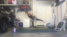 a woman is doing yoga in the garage