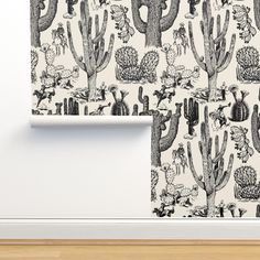 cactus wallpaper in a room with white walls and wood flooring on the side