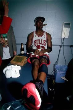 a basketball player sitting in the locker room