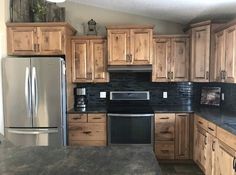 a kitchen with wooden cabinets and stainless steel appliances