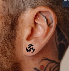 a man with a tattoo on his ear