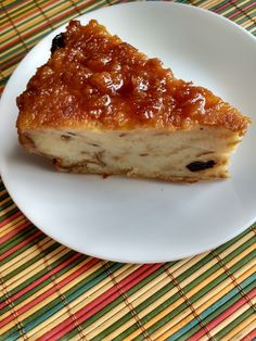 a piece of cake sitting on top of a white plate next to a colorful place mat