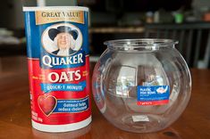 a can of oats next to a glass vase on a table