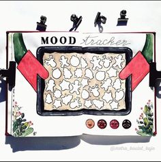 a drawing of a tray with food on it that says mood tracker and has an arrow pointing to the top