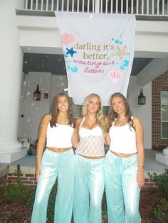 three beautiful young women standing next to each other