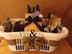 a white basket filled with different types of utensils and personalized napkins