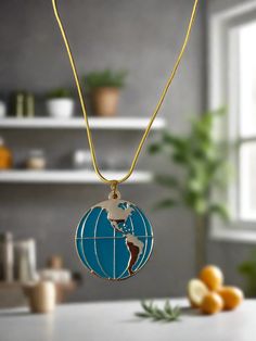 Description Wear this necklace with an adventurous feeling using elements such as this Globe Locket necklace! This metal pendant opens up to reveal a hollow interior and a magnetic closure. The exterior boasts a double-sided map of the world with enameled, turquoise blue oceans. Details chain length: 16-18" (chain might be slightly different than in the pic) Pendant: Globe Locket Length: 1 7/16 " Width: 1 1/4" Metal Color: Gold Features One of a kind, fashion jewelry, everyday jewelry Great gift Blue Round Pendant Jewelry With Chain, Blue Round Pendant Chain Jewelry, Blue Jewelry With Chain And Round Pendant, Blue Jewelry With Round Pendant Chain, Blue Metal Charm Necklace With Round Pendant, Blue Stainless Steel Necklace, Blue Stainless Steel Round Necklace, Blue Enamel Necklaces With Lobster Clasp, Turquoise Metal Round Pendant Jewelry