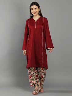 Bing Cherry Maroon Loose V Neck Kurta In Bell Sleeves With Ivory Floral Straight Pant Bing Cherry Maroon kurta with playful summer floral print pant Kurta can also be styled just as a dress Cotton poplin kurta with lace neck line, bishop sleeve and elasted pant waistband detail for relaxed summer look Cold wash and Dry clean only Product doesn't have lining Lining Material: No lining Pattern: Solid, Floral Print Fit: Loose Model Height: The model (height 5'7", Chest 34", Waist 28", Hip 38") is w Casual Floral Print Sets For Festive Occasions, Casual Cotton Pant Set With Floral Print, Casual Festive Sets With Straight Pants, Churidar Styles, Designer Red Straight Kurta, Red Palazzo Set With Straight Kurta, Red Long Sleeve Kurta With Motifs, Festive Long Sleeve Burgundy Kurta, Red Fitted V-neck Kurta