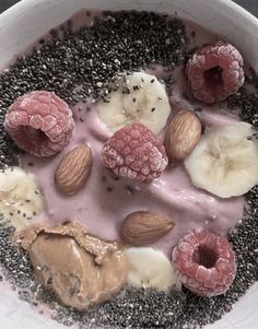 a white bowl filled with fruit and nuts