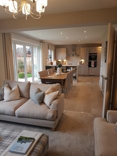 a living room filled with furniture and a large window