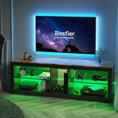 a television that is sitting on top of a cabinet in a room with green lighting