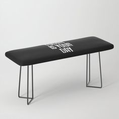 a black bench with white writing on the back and legs that says, today is your day