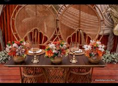 the table is set with place settings and flowers