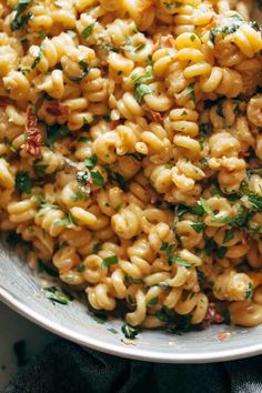 a bowl full of macaroni and cheese with parsley