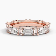 a rose gold ring with baguets and diamonds on the sides, set in 18k