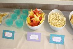 there are many different foods in bowls on the table