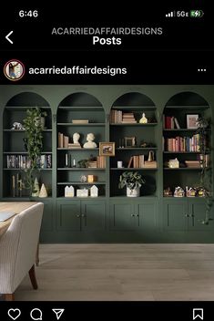 an image of a dining room setting with green bookcases and white table chairs