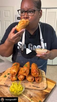 a woman is eating some food on a cutting board