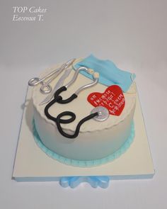 a cake decorated with a stethoscope, heart and medical equipment on top