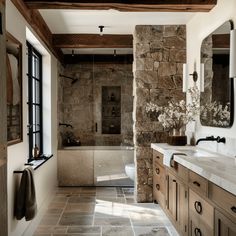 a large bathroom with stone walls and flooring