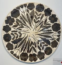 a white and black plate sitting on top of a wall