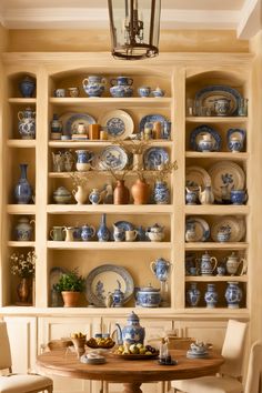 a dining room table with blue and white china on it