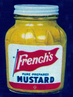 a jar of mustard sitting on top of a table