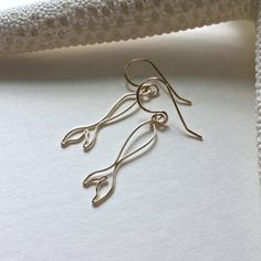 Made to order. Please see my policies page or my shop announcement for current production times on made to order items. My hand formed wire mermaid tails now come in an itty bitty size! All five pictures include the gold filled version, with the last two also including sterling silver and rose gold filled. Find the full sized mermaid tails here (picture 3): https://www.etsy.com/listing/256960329/mermaid-tail-earrings-fish-tail-earrings ~ gold filled, rose gold fille... Mermaid Wire Jewelry, Summer Ocean-inspired Earrings With Ear Wire, Wire Fish Earrings, Wire Mermaid, Siren Earrings, Sterling Silver Ocean-inspired Earrings With Ear Wire, Shell-shaped Beach Earrings With Ear Wire, Handmade Mermaid Earrings For Gift, Tiny Mermaid