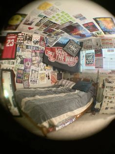 a bed with lots of stickers on the wall next to it and a mirror