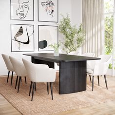 a dining room table with chairs and pictures on the wall above it, along with an area rug