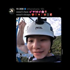 a young man wearing a helmet and holding onto the side of a zip line with words written on it