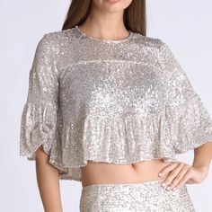 Classy, Chic And Gorgeous; This Viky Top Is The Complete Package. This Sequined Crop Top Features A Flattering Rounded Neckline, And Half-Sleeves With A Slight Flare At The Ends. Be A Stunner In This Top Paired With The Viky Mini Or Maxi Skirts! S/M Fits Perfectly Sizes From 0-4, M/L Fits Sizes From 6-10. Silver Sequin Blouse For Party, Fitted Silver Glamorous Blouse, Fitted Silver Top For Holiday, Fitted Silver Top For Holidays, Fitted Silver Sequined Blouse, Glamorous Silver Shimmer Tops, Silver Sequined Tops For Festive Occasions, Glamorous Silver Blouse For Spring, Holiday Silver Sequined Tops