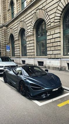 a black sports car parked in front of a building