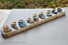 a group of little birds sitting on top of a piece of metal with different colors